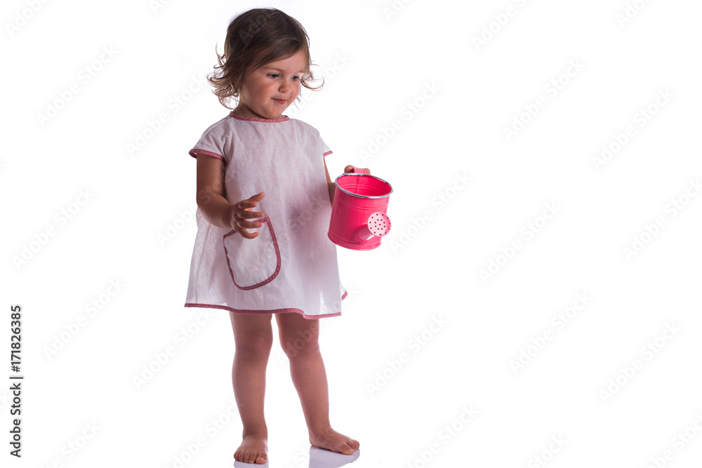 Studio portrait of cute baby girl hanging water can on white background Studio portrait of cute baby girl hanging water can on white background