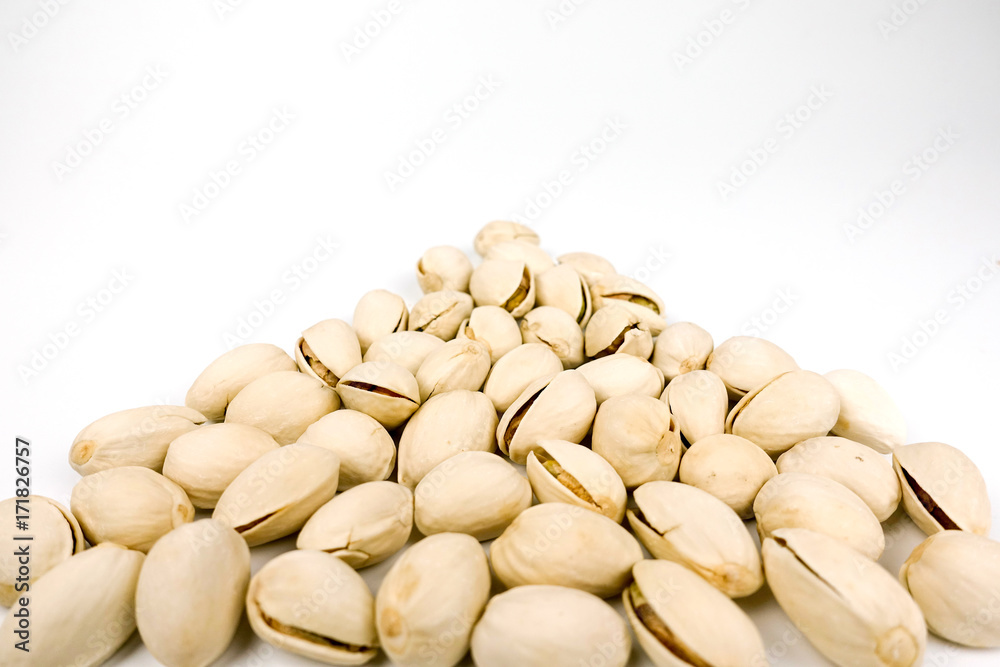 salted pistachio nuts on white background salted pistachio nuts on white background