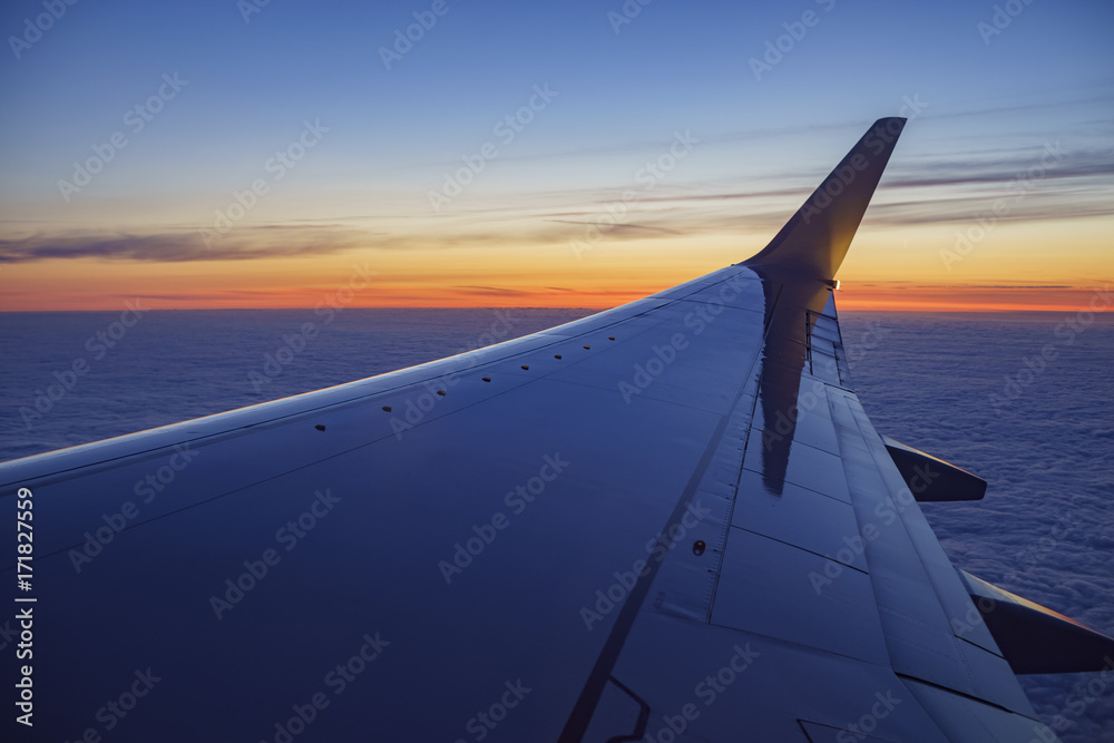 Sunset view of sky from a window seat in an airplane