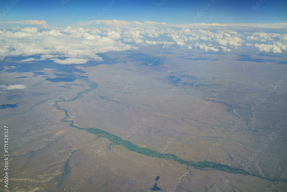 Fototapeta premium Aerial view of Badwater Creek, view from window seat in an airplane