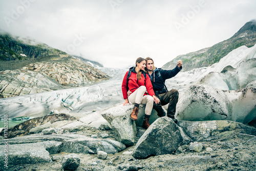 Young Couple Hiking In The Swiss Alps, Taking A Selfie