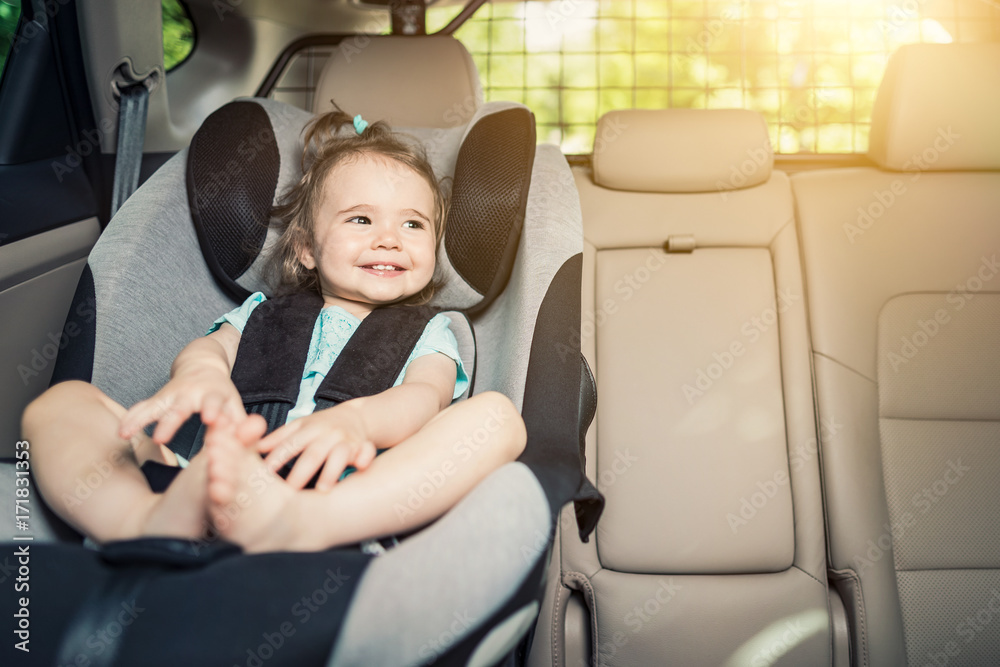 Infant baby girl buckled into her car seat. Infant baby girl buckled into her car seat.