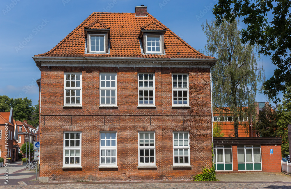 Old house at a cobblestoned street in Aurich