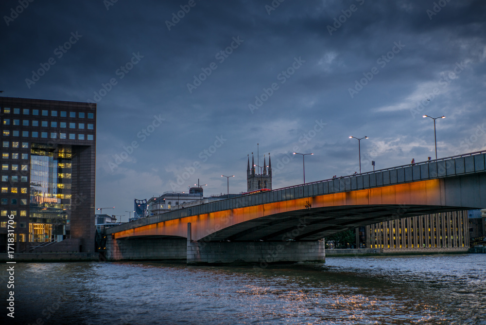 Colorful lights on the London bridge in London at sunset