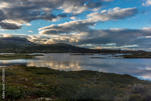 Clouds reflecting on a Norwegian lake at sunset in the Rondane National Park in Norway