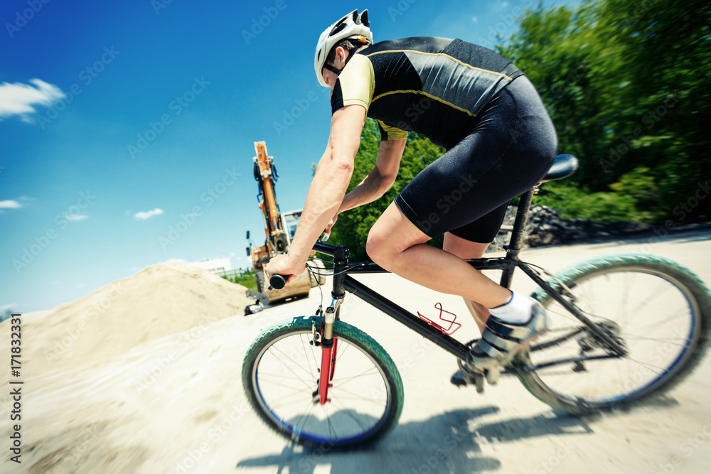 Fototapeta premium Young Man Riding His Mountain Bike