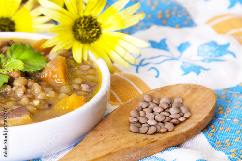 tasty lentil stew on colorful tablecloth