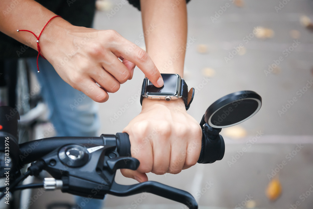 Smart watches are helping the cyclist on the street, hand in close-up ...
