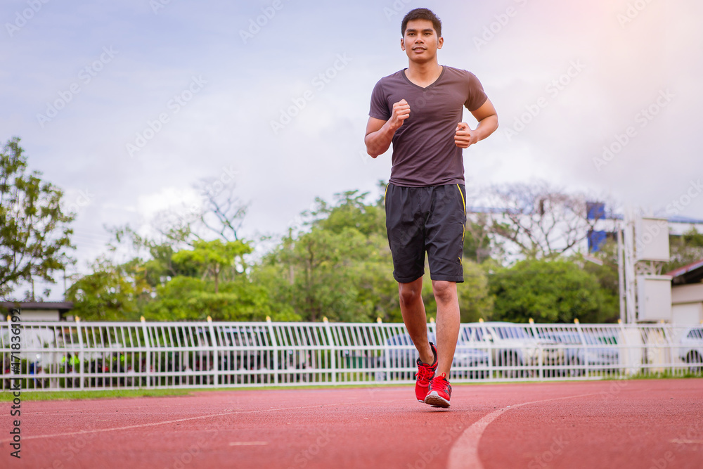 man running in the track. Fit male fitness runner jogging in stadium Stock Photo Adobe Stock