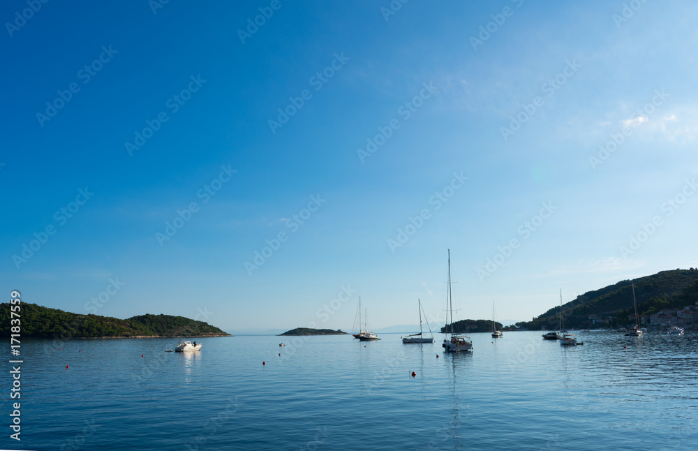A quite tranquil early morning in a bay, moored sailing boats