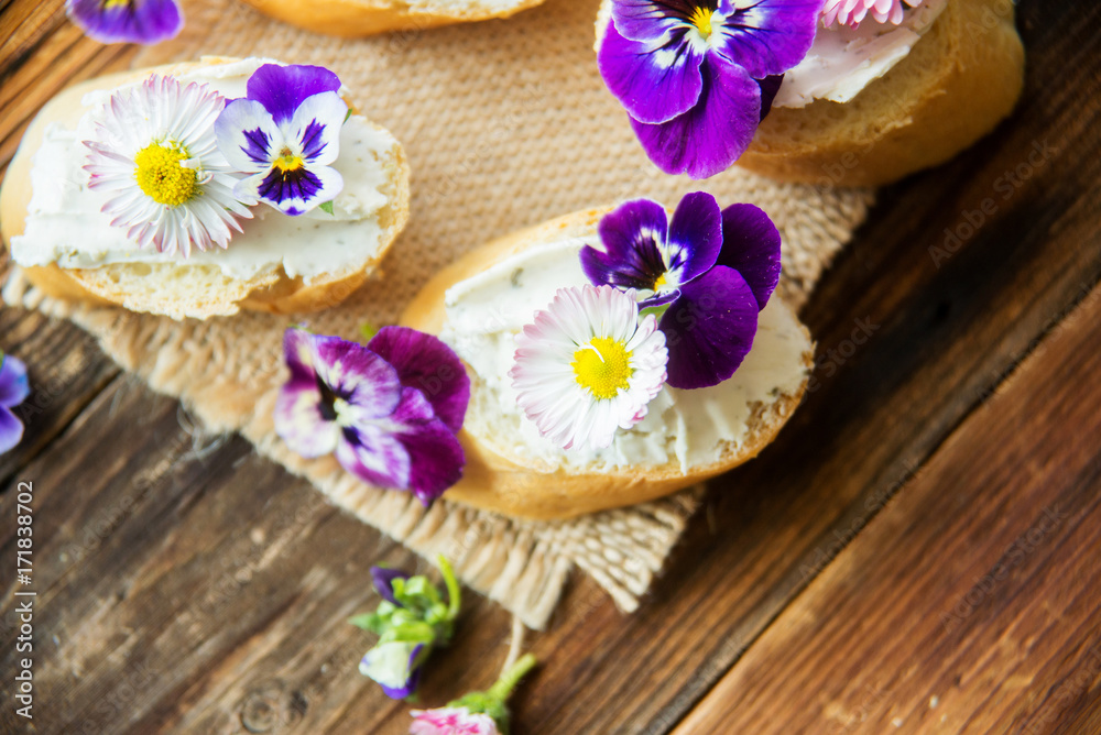 Sandwich with herb and edible flowers butter on marble cutting board. Healthy food. Sandwich with herb and edible flowers butter on marble cutting board. Healthy food.