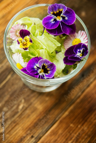 Fresh green salad with herbs and garden flowers. Healthy food concept