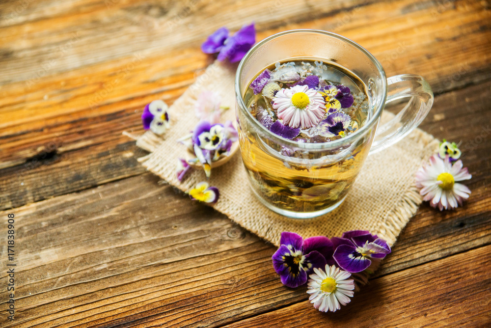 Cup of tea with chamomile flowers on rustic wooden background Cup of tea with chamomile flowers on rustic wooden background