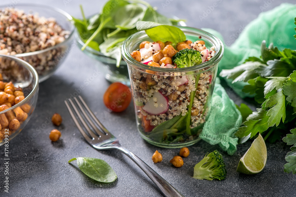 Quinoa salad with chickpeas, spinach, avocado and veggies, healthy vegan food, dieting, clean eating, vitamin and protein snack Quinoa salad with chickpeas, spinach, avocado and veggies, healthy vegan food, dieting, clean eating, vitamin and protein snack