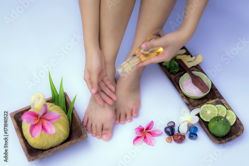 Spa treatment and product for feet spa with flowers and water  wooden background  select and soft focus.