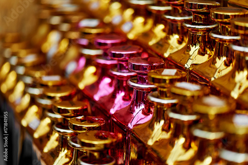 Glass perfume bottles based oils. A Bazaar, market. Macro. Gold and pink gamma