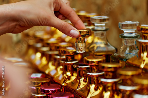 Glass perfume bottles based oils. A Bazaar, market. Macro. Gold and pink gamma photo
