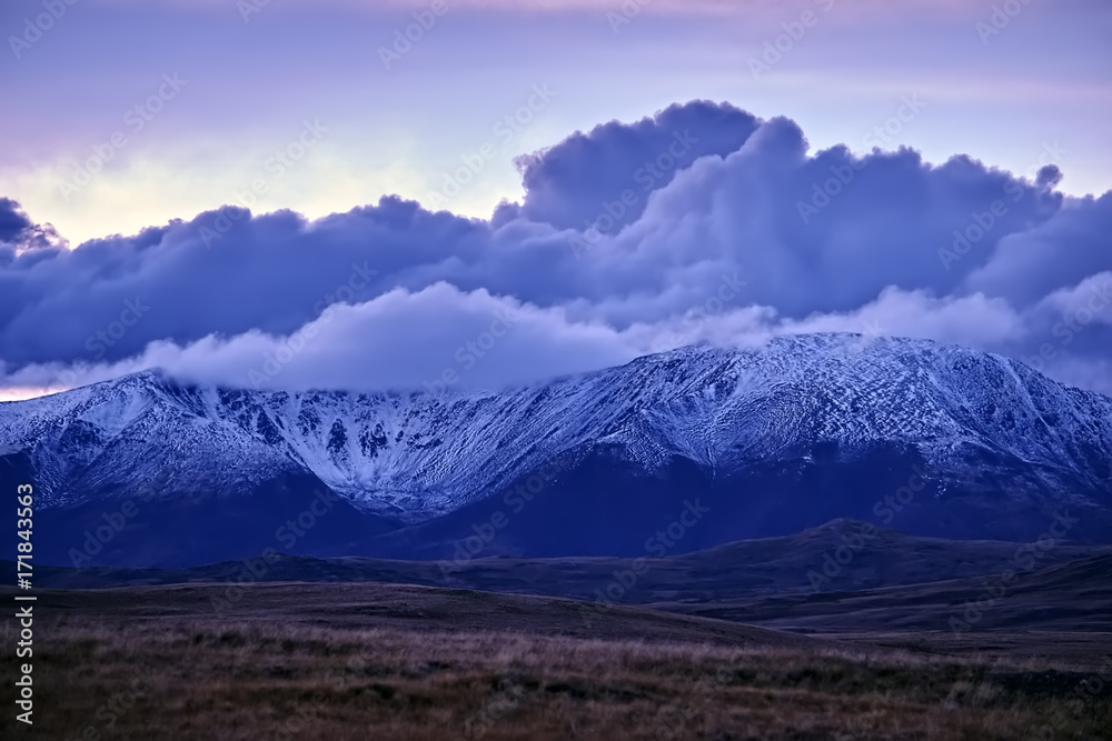 Fototapeta premium Beautiful autumn sunset landscape in the snow-capped mountains in the Altai.