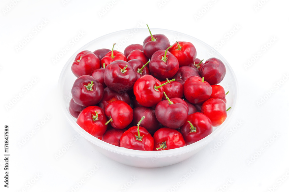 red cherries in plastic bowl on white background red cherries in plastic bowl on white background