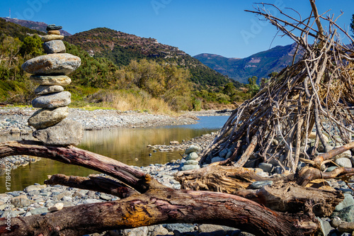 A hut of drifting wood together with a cairn at the beach of Catarelli. photo