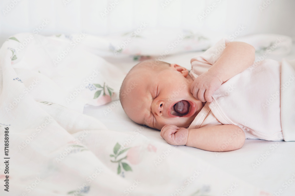 Newborn baby girl sleeps and yawning. Newborn baby girl sleeps and yawning.