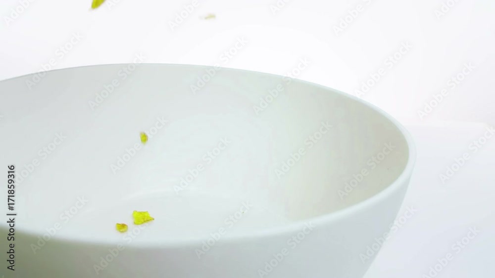 cereal corn flakes falling down in a bowl, shot in slow motion on white background, concept of diet healthy food nutrition cereal corn flakes falling down in a bowl, shot in slow motion on white background, concept of diet healthy food nutrition