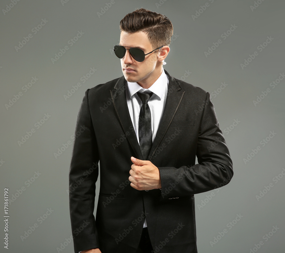 Handsome security guard on grey background Handsome security guard on grey background
