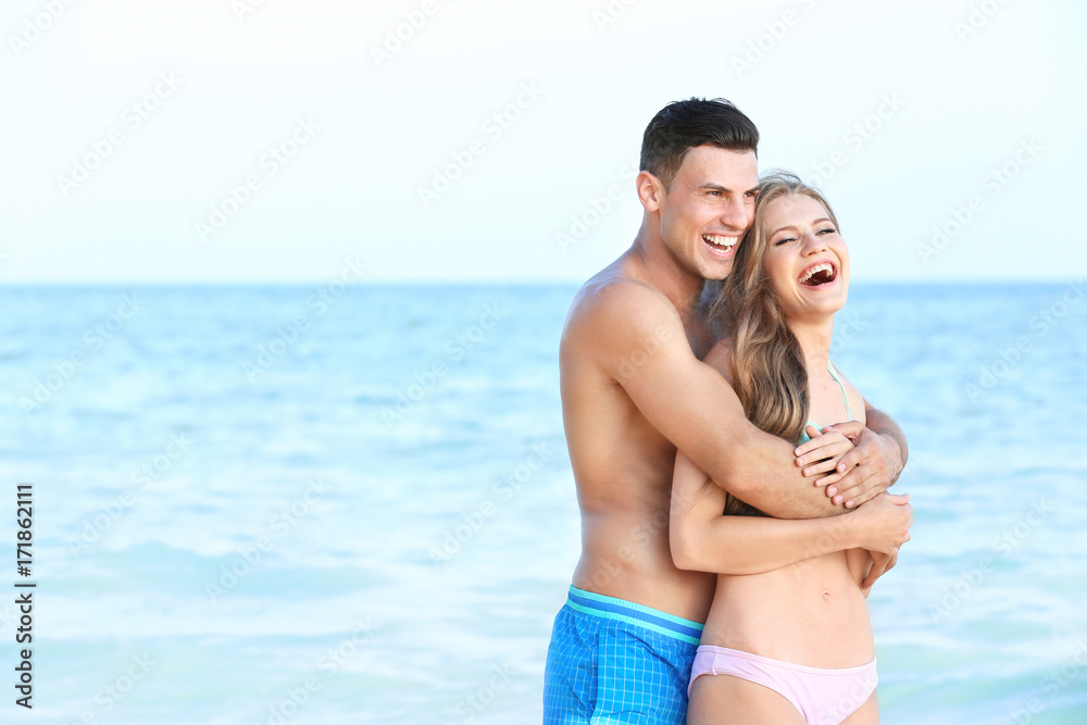 Happy young couple on sea beach Happy young couple on sea beach