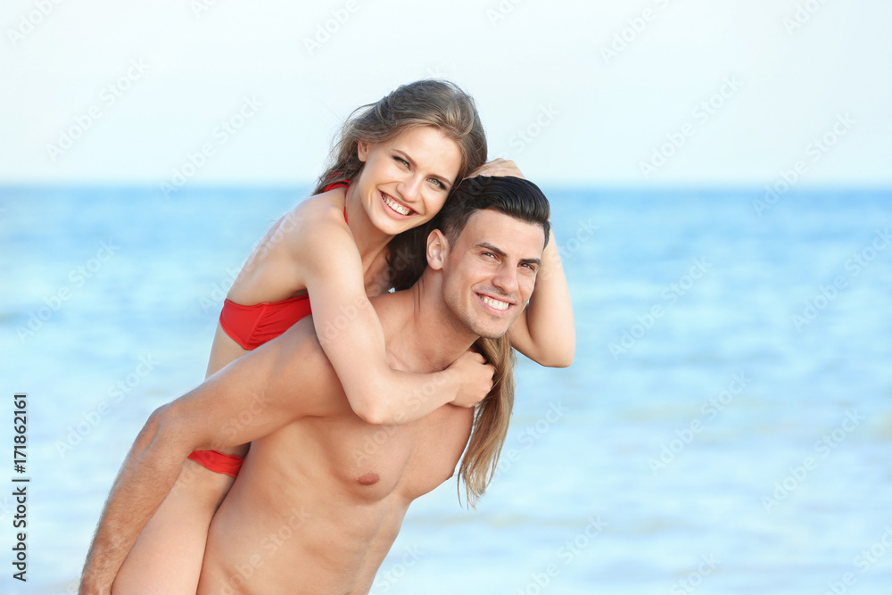Happy young couple on sea beach Happy young couple on sea beach