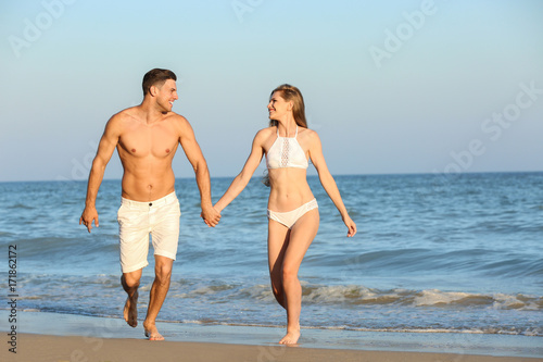 Happy young couple on sea b...