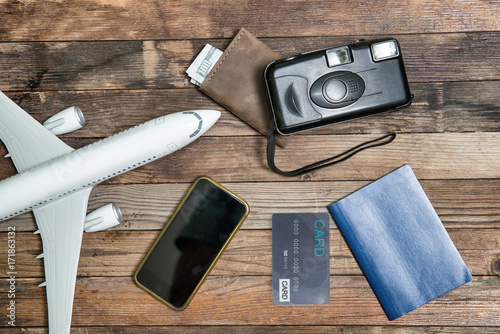model airplane, camera, card, smartphone and passport