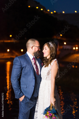 Wedding couple by the lake at night photo