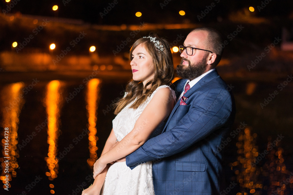 Wedding couple by the lake at night Wedding couple by the lake at night
