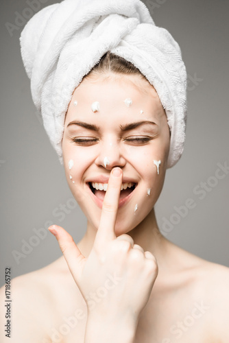 Beauty skin care, woman applying cream on face,fun teen
