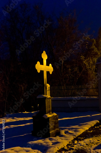 Black marble cross at night in monastery yard, monastery Beocin, Serbia photo