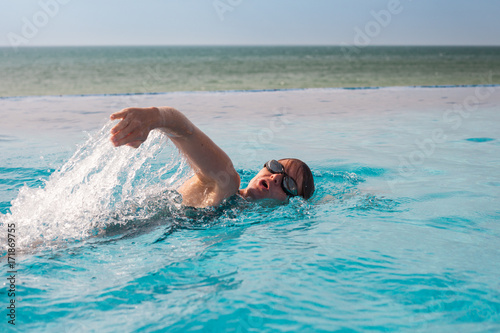 Woman swimming in a crawl style an a pool