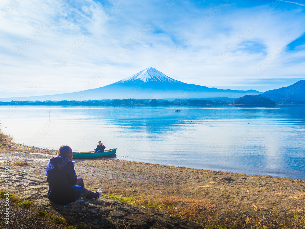 asia girl traveler 30s to 40s sit and see her boyfriend sit on boat at side of lake kawaguchi on morning time with fuji mountain background asia girl traveler 30s to 40s sit and see her boyfriend sit on boat at side of lake kawaguchi on morning time with fuji mountain background