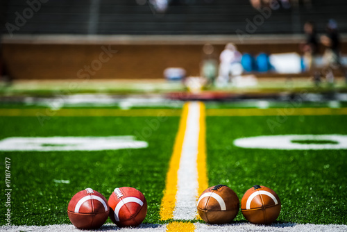 Footballs on 50 yard line, daytime