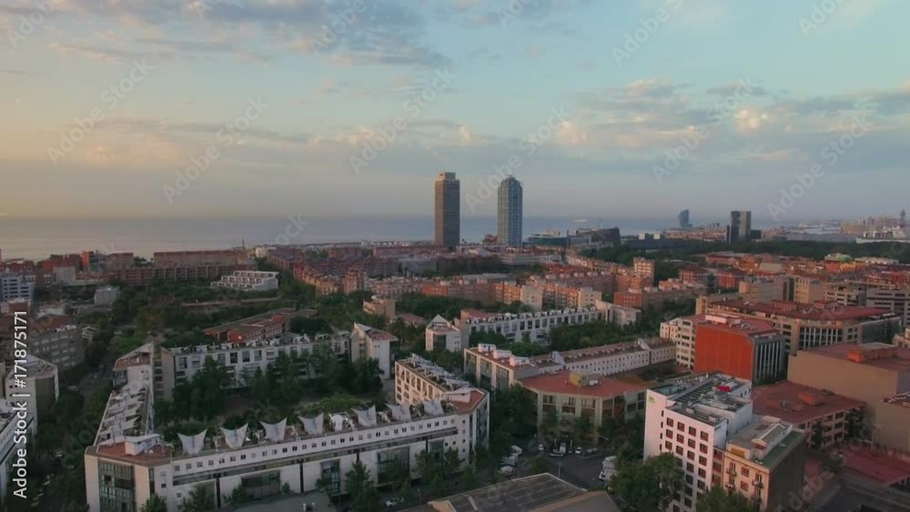 Drone turns around and gives panorama of beautiful early morning city waking up from nigh time sleep, with parks and inner gardens inside apartment blocks, city organized in grid Drone turns around and gives panorama of beautiful early morning city waking up from nigh time sleep, with parks and inner gardens inside apartment blocks, city organized in grid