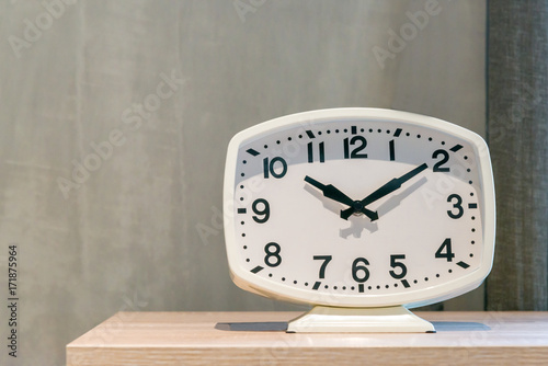 Modern white clock on the wooden table luxurious contemporary decoration