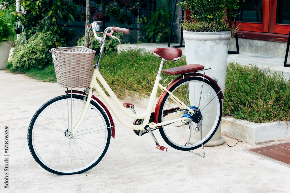 Fototapeta premium Old Ancient Bike On House Wall At Sunset,Copy Space for Text. (Vintage Style)