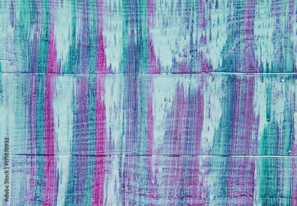 Pink, white, blue and purple streaks on wood background