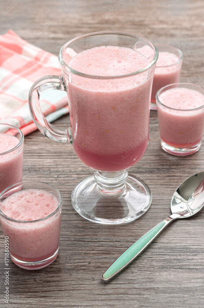 Berry smoothie pink on a wooden table. selective focus Berry smoothie pink on a wooden table. selective focus