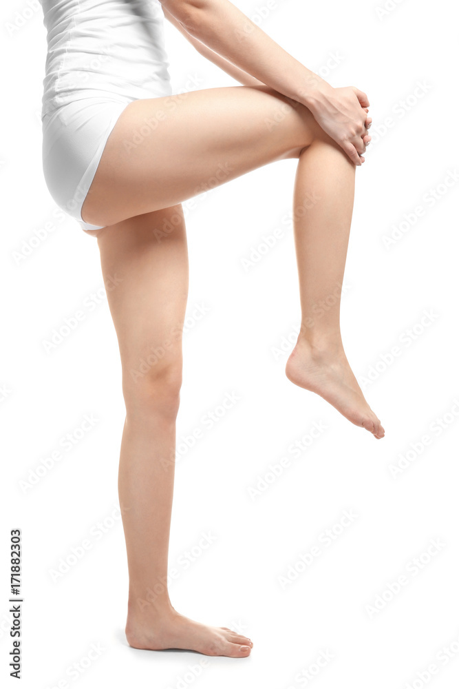 Young woman suffering from leg pain on white background Young woman suffering from leg pain on white background