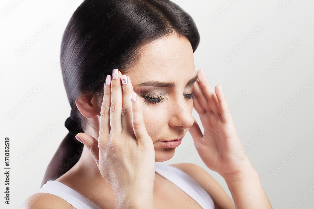 Headache And Stress. Beautiful Young Woman Feeling Strong Head Pain. Portrait Of Tired Stressed Female Suffering From Painful Migraine, Holding Hands Near Face. Health Care Concept. Headache And Stress. Beautiful Young Woman Feeling Strong Head Pain. Portrait Of Tired Stressed Female Suffering From Painful Migraine, Holding Hands Near Face. Health Care Concept.