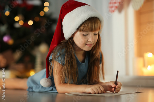 Cute girl in Christmas hat ...