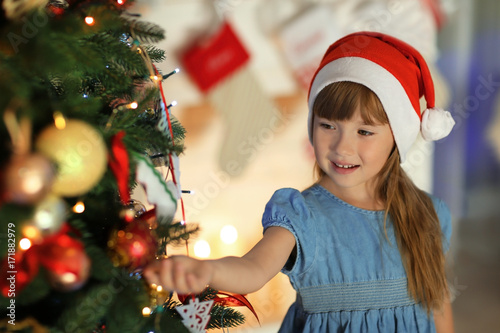 Cute little girl in Santa h...