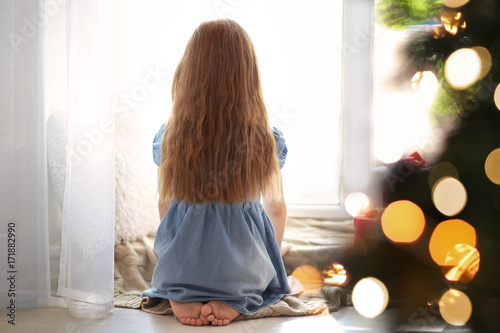 Cute little girl sitting ba...