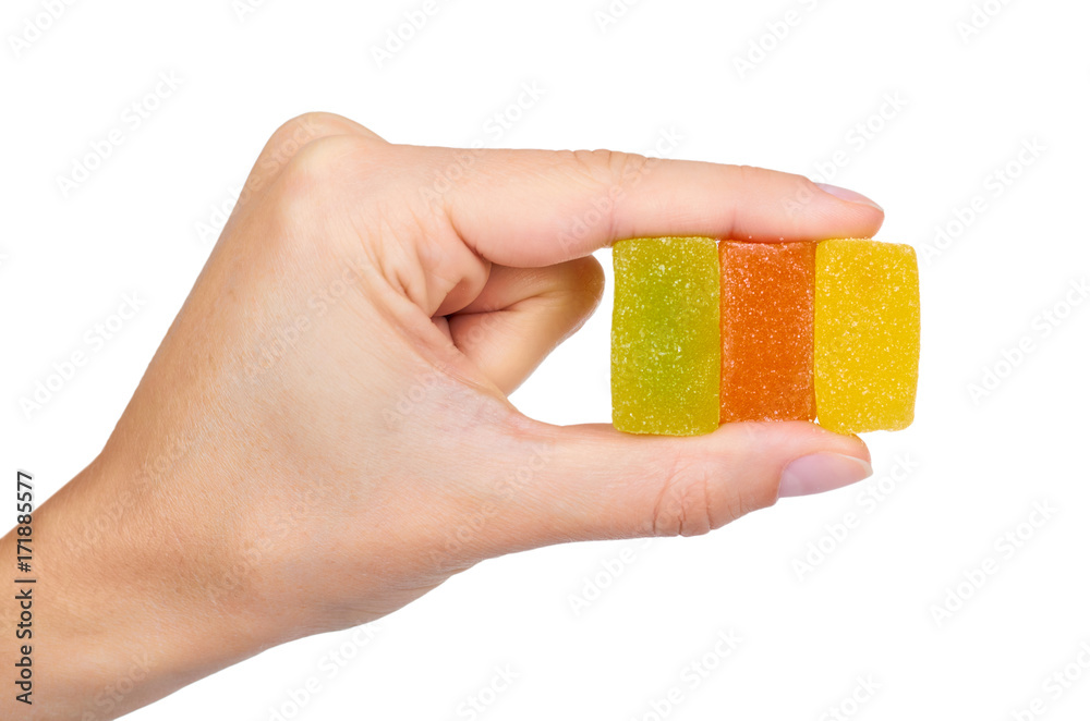 Fototapeta premium Various color of fruity gummy jelly candies in hand isolated on white background