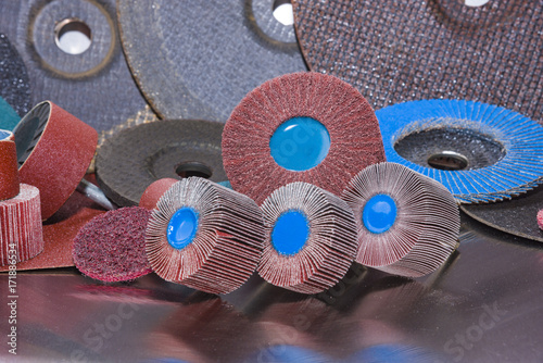 Картината върху платно Flap Wheel. A pile of color abrasive sandpaper for metal working